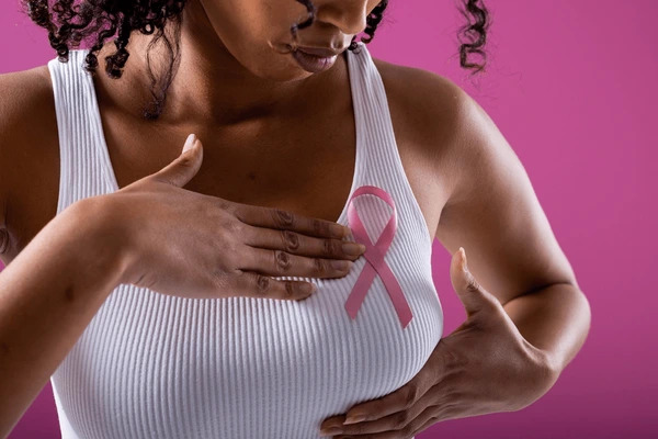 bbc Black women waering a white shirt with a pink breast cancer ribbon