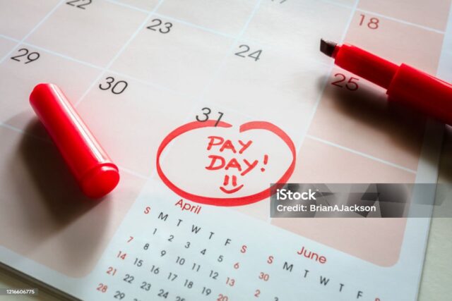 Payday end of month date on calendar with red marker and circled salary day payday