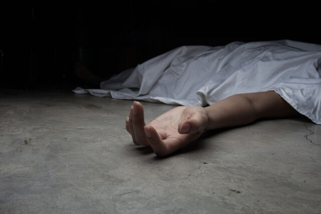 akatsi headteacher found dead a hand extending from underneath a white sheet covering a body on the floor.